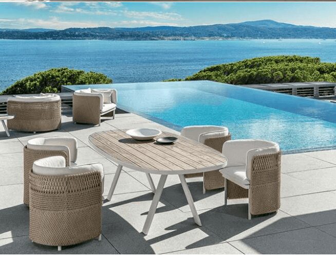 Table and chairs placed near a swimming pool